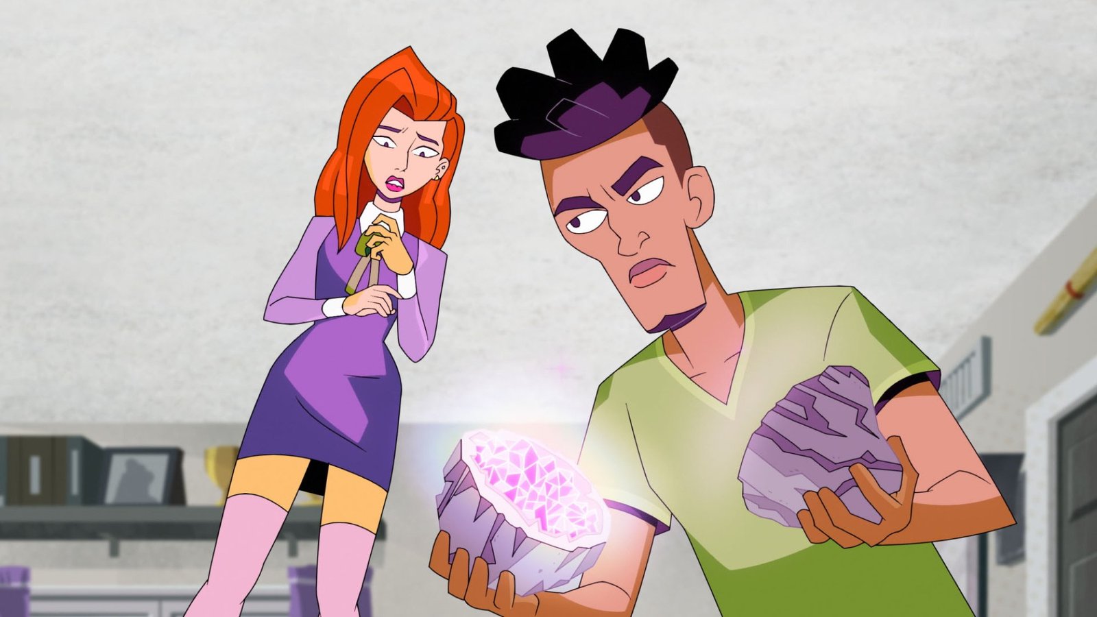 images-1-fill_-size_2000x1125-v1673375701 A young woman in a purple dress and a young man in a green shirt examine a purple geode.