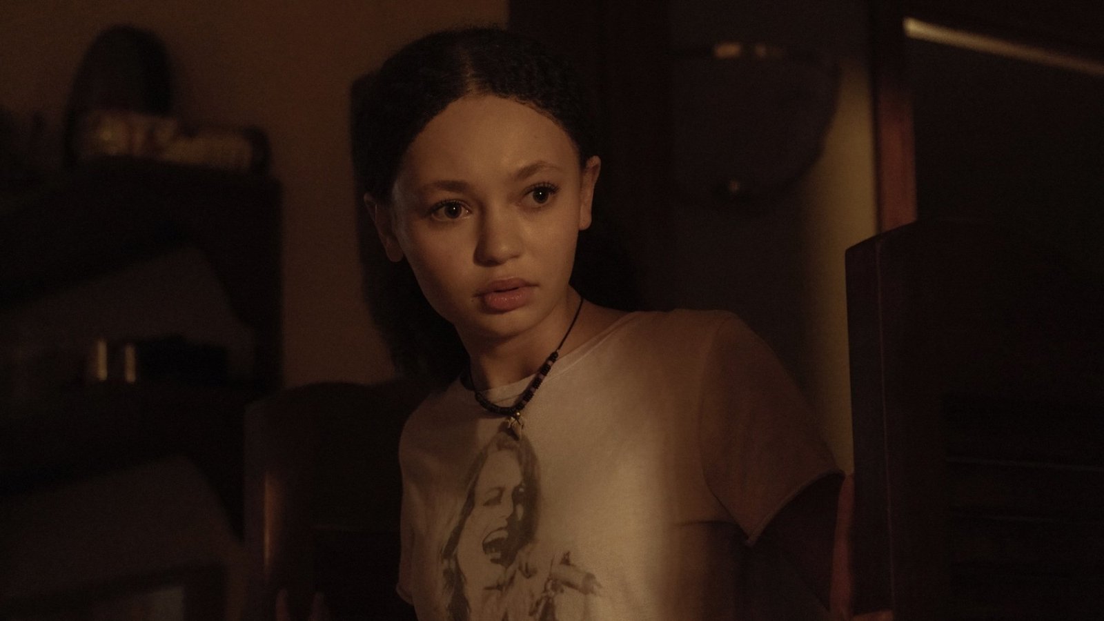 Sarah from "The Last of Us" peers into a kitchen.