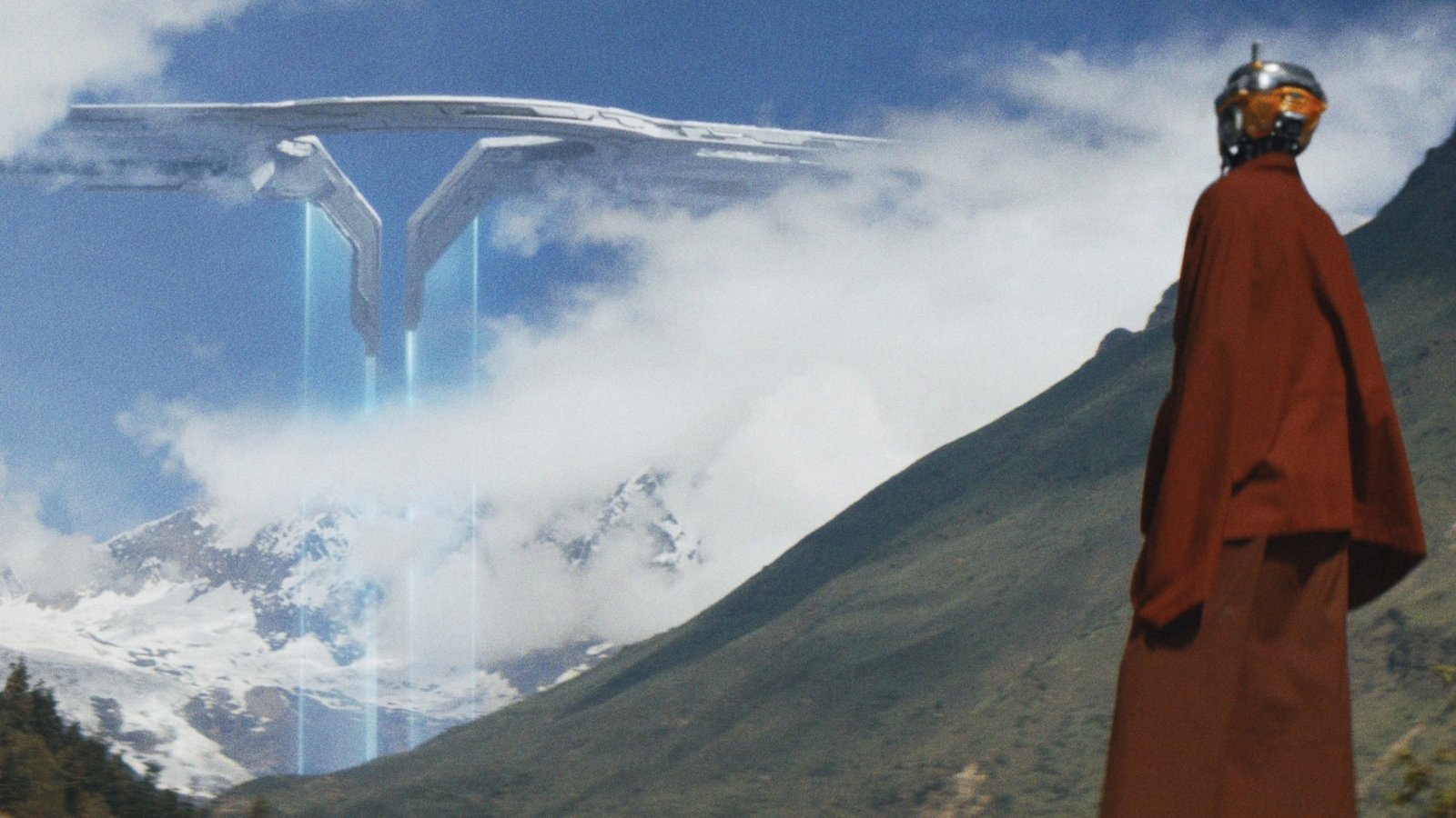 A tall robot in red robes stands on a green mountainside, watching a large space station drawing nearer.