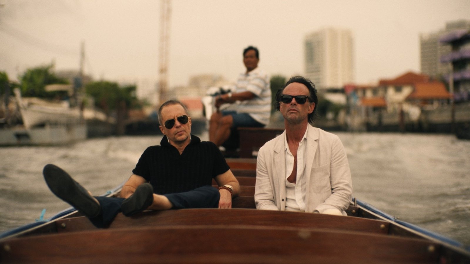 Sam Rockwell and Walton Goggins sit in a boat in “The White Lotus.”