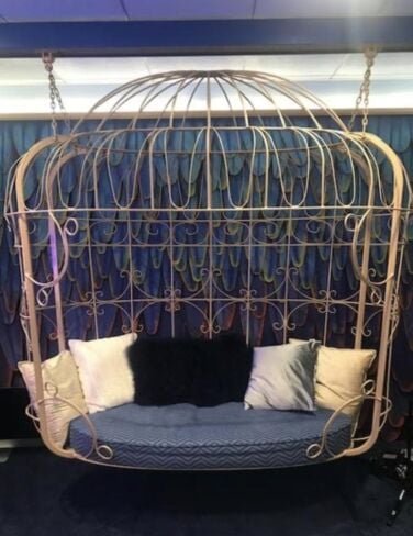 images-10-fit_lim-size_376x Gold hanging cage surrounding a blue bench.