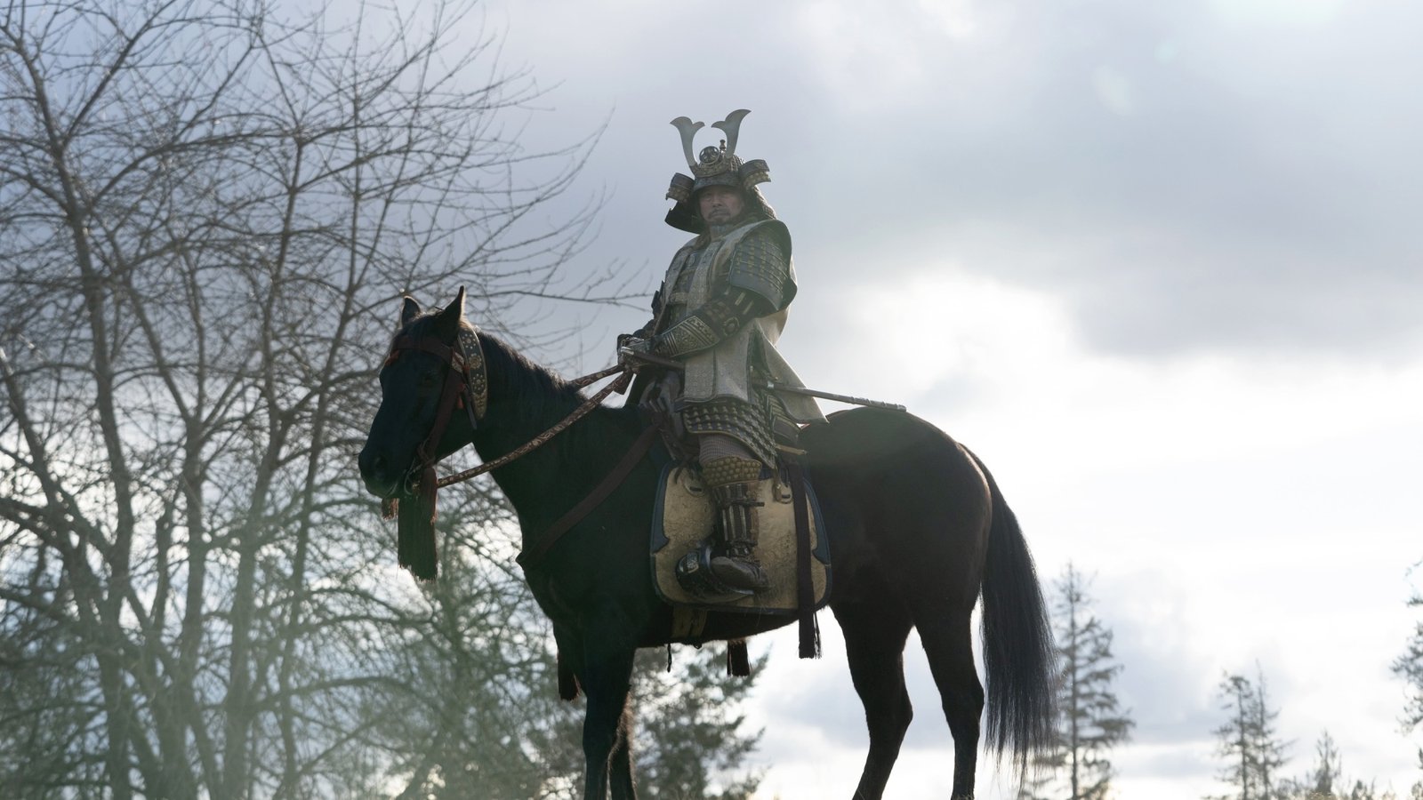 A man in samurai armor on a horse.