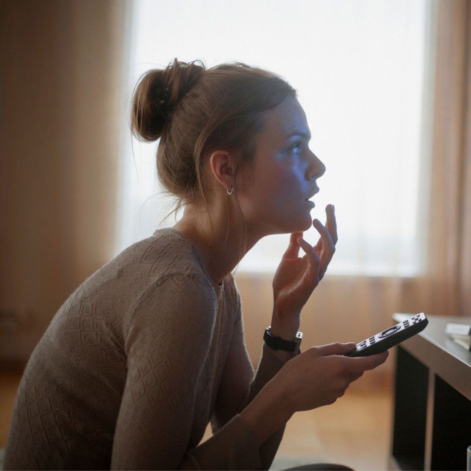 images-2-fill_-size_2000x2000-v1680281486 Young woman looking in suspense at tv