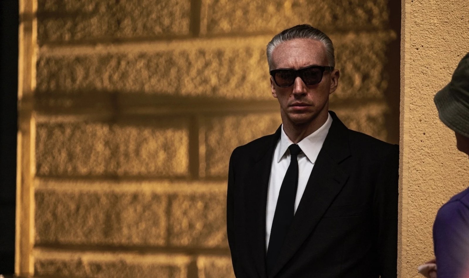 A man with grey hair in a suit.